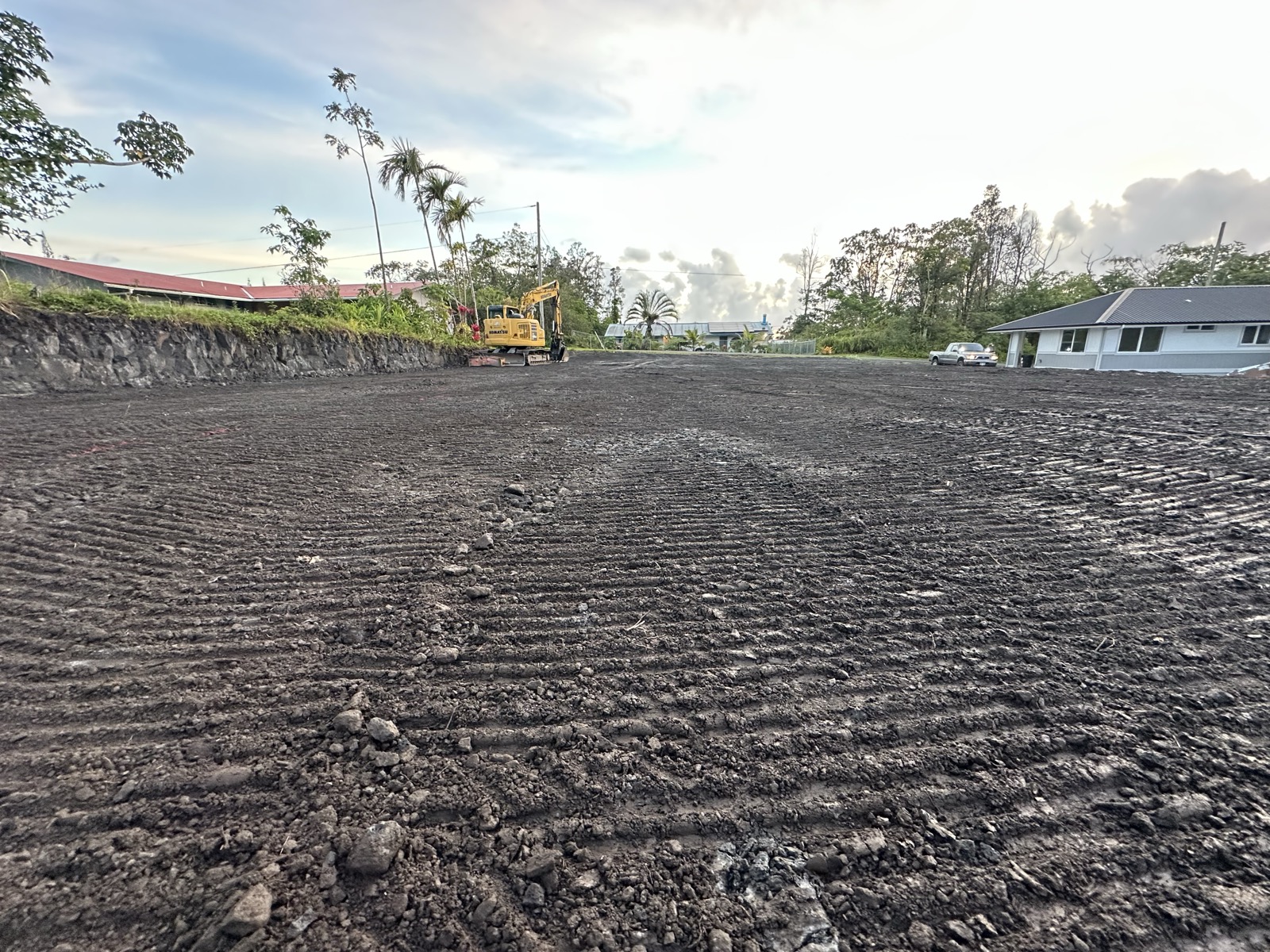J Boys Services freshly graded lot on Big Island with excavator in background